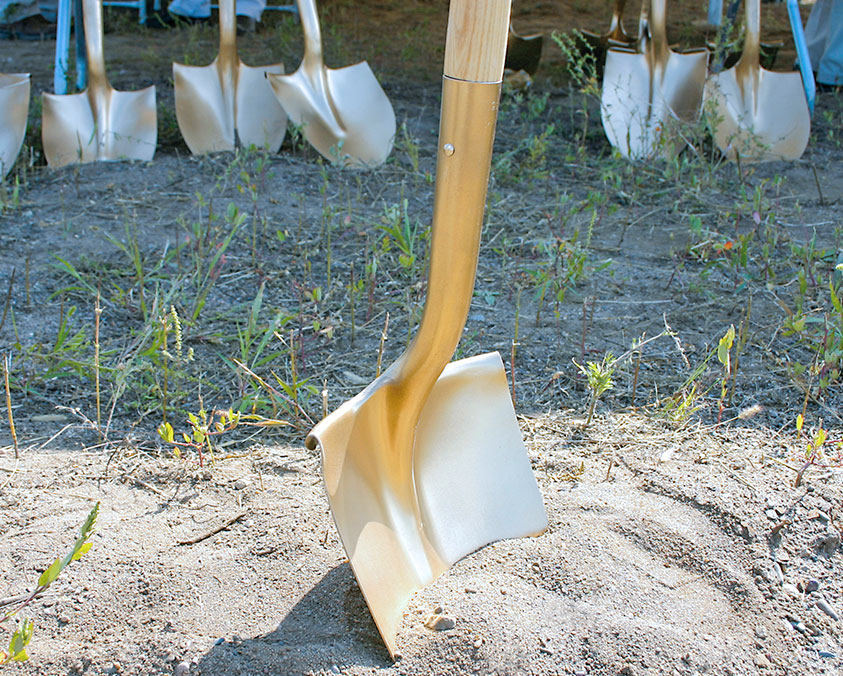 Ceremonial groundbreaking shovel in the ground.