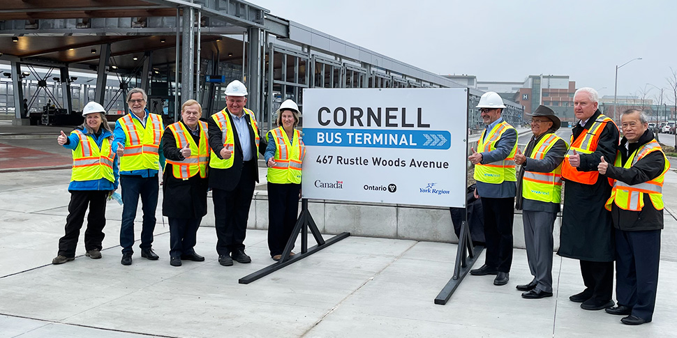 A man and woman cue to board a viva bus